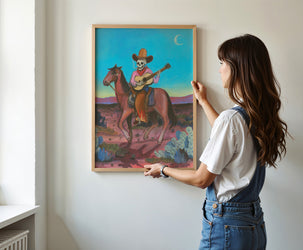 Skeleton Highwayman western art print by Caya Crum — framed vertical room scene