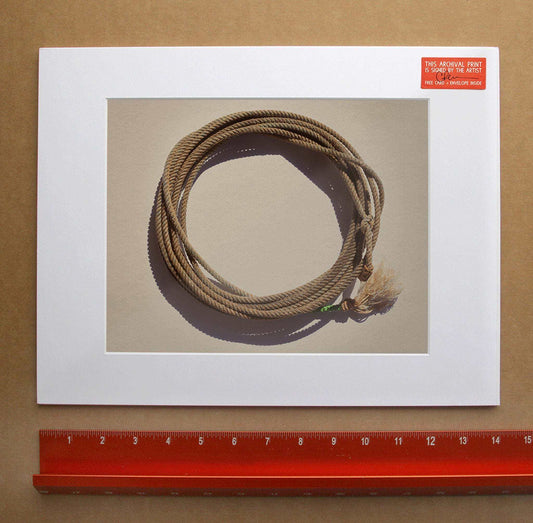 Modern Lasso Photograph print by Crum Art on cotton rag paper with a coiled lasso rope displayed above a red ruler.