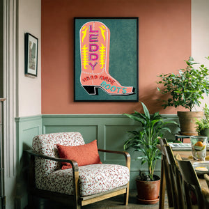 Pink Leddy boot art print by Betsy Crum framed in a soft neutral corner