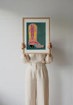 Leddy Boots Pink cowboy boot art print by Betsy Crum — framed with velvet mat