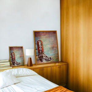 Leddy Boots Big Sky cowboy boot art print by Betsy Crum — framed in a wood-accent room