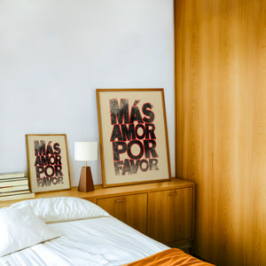 Mas Amor Por Favor typography print by Betsy Crum — framed in a wood-accent room