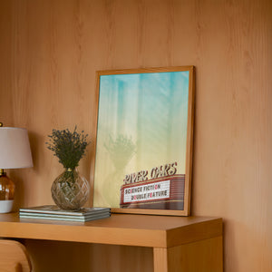 River Oaks Theatre Houston art print by Betsy Crum — framed in a wood-accent room