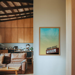 River Oaks Theatre Houston art print by Betsy Crum — framed in a wood-accent room
