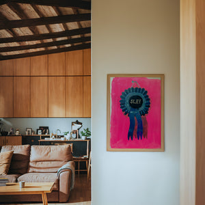 Slay Ribbon funny wall art print by Caya Crum — framed in a wood-accent room