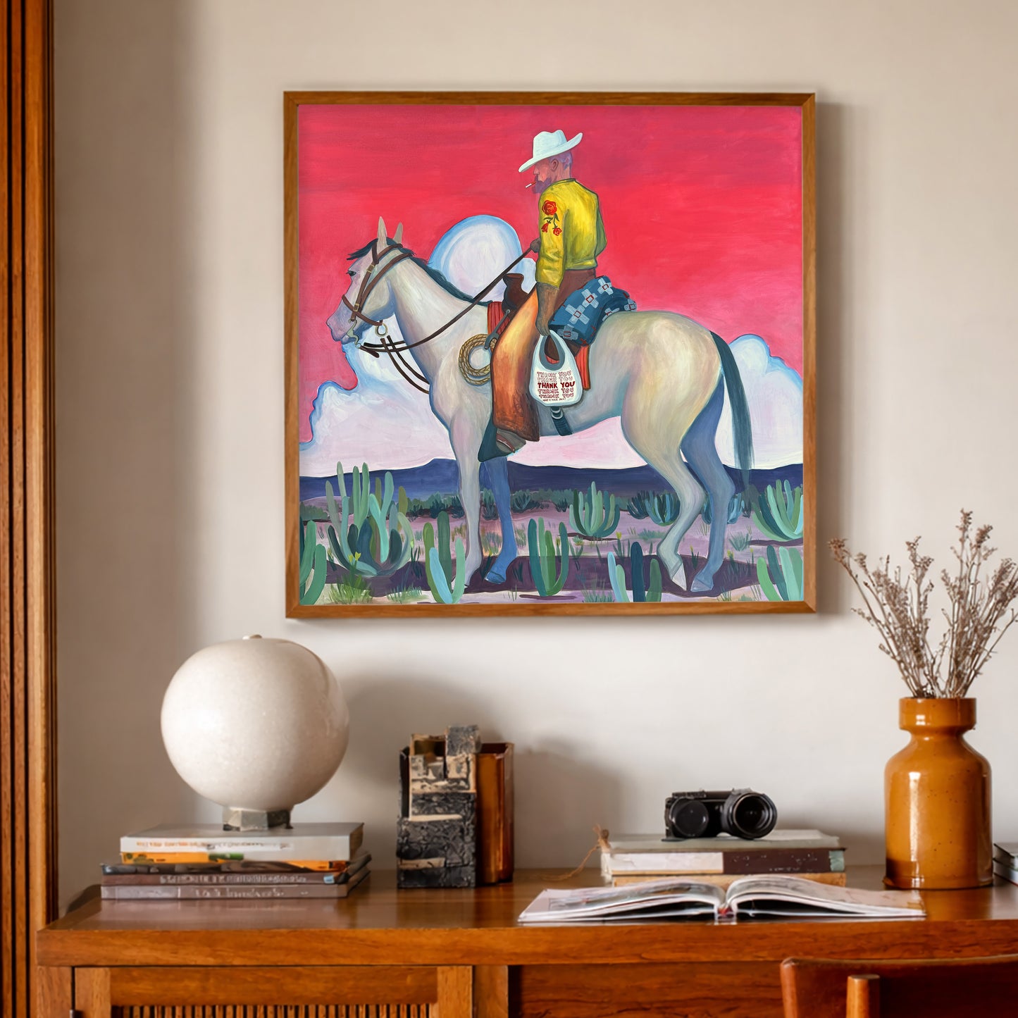 Smoking Cowboy Print features a cowboy with cigarette in his mouth and thank you bag by his side.  The pink sky give this work and other worldly feel.  Western Nostalgia combined with Cosmic Desert Energy gives a life force to this work created by Fort Worth Texas artist Caya Crum. This Texas Art Print is made in Texas.