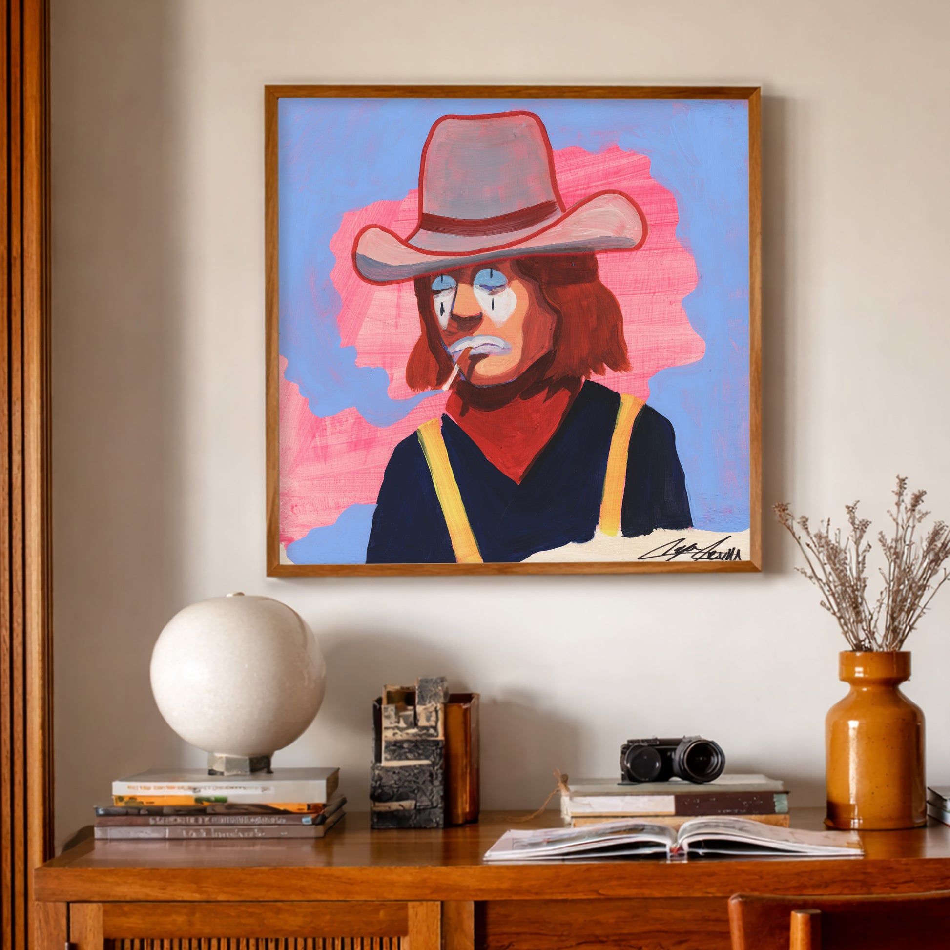 Smoking Cowboy Rodeo Clown Art Print by Caya Crum, inspired by melancholy cowboy clown energy, bold western portraiture, and a pink-and-blue palette that makes this piece feel both funny and unforgettable, available at crumart.com. This museum quality print is made right here in Texas.