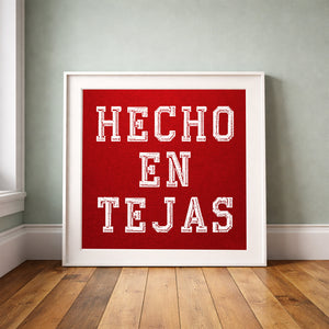 Hecho en Tejas print by Carl Crum framed upright against a grey-green wall