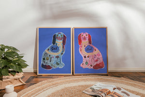 Good Luck Staffordshire dog print pair by Caya Crum framed and leaning against a wall on a wood floor
