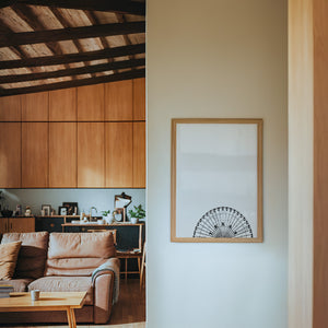 Texas Star Ferris Wheel Texas art print by Betsy Crum — framed in a wood-accent room
