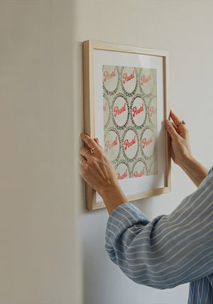 Pearl Beer bottle caps art print by Betsy Crum framed on a styled wall