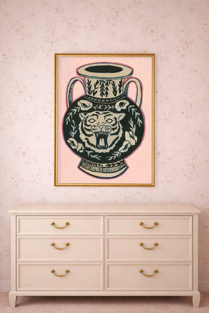 This tiger art print by Caya Crum is in a greco-roman style.  It is a black amphora (vase) with a pink background.  The setting for this is in a pink bedroom above a dresser.