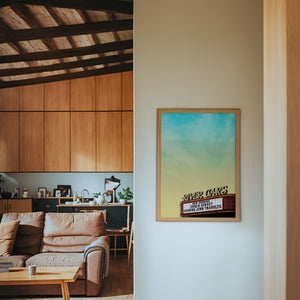 River Oaks Theatre Houston art print by Betsy Crum — framed in a wood-accent room