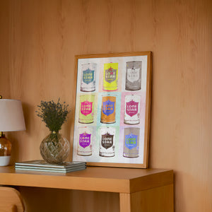 Nine Lone Star Cans bar wall art print by Betsy Crum — framed in a wood-accent room