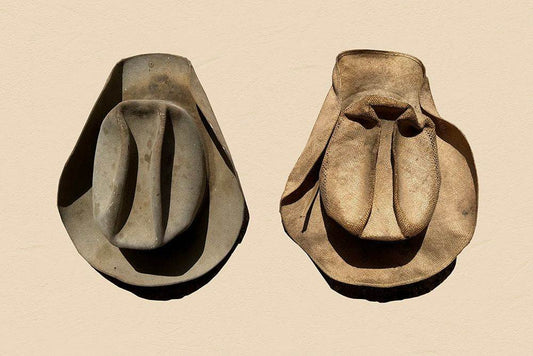 Vintage well-worn winter and summer hats representing Comp Arnold's Texas farming heritage