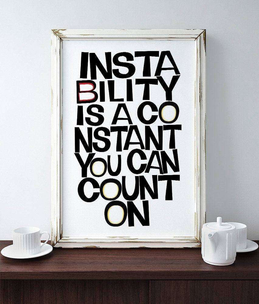 Instability Is A Constant modern art print by Betsy Crum in white frame on wooden table with teapot and cup