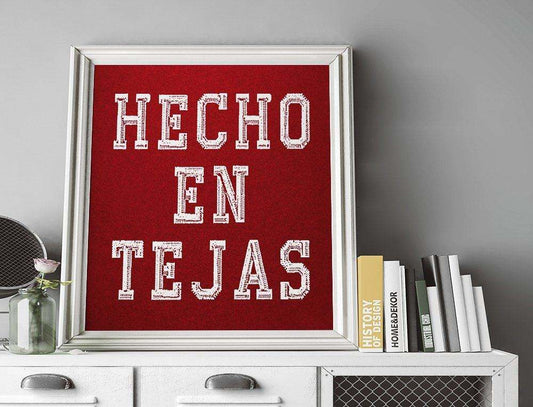 Hecho En Tejas art print in white text on red background framed for Texas wall decor by Betsy Crum