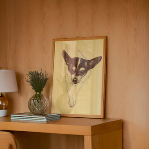 Edie the Rodeo Dog art print by Caya Crum — framed in a wood-accent room