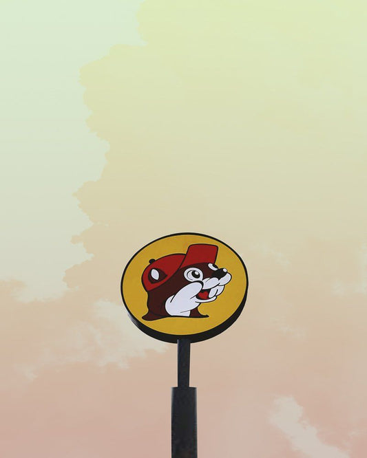 Bucee's Texas logo sign against a soft pastel Texas sky background