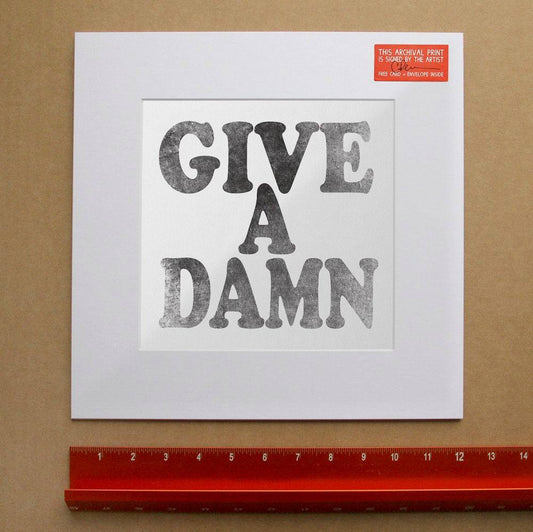 Black and white "Give A Damn" print on matted paper with artist signature and archival quality inks