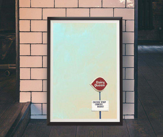 Framed art print of a Dairy Queen Chicken Strip Country Basket sign against a pastel blue background displayed on a brick wall.