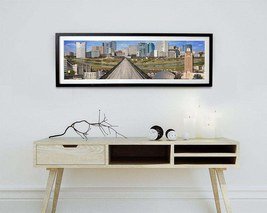 Framed Fort Worth Skyline art print by Betsy Crum above modern wooden console table with decorative items in minimalistic room