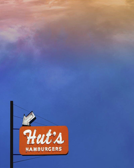 Hut's Hamburgers sign in Austin Texas under a colorful sunset sky museum print