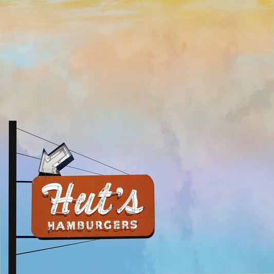 Vintage Hut's Hamburgers sign in Austin Texas against a colorful sky background