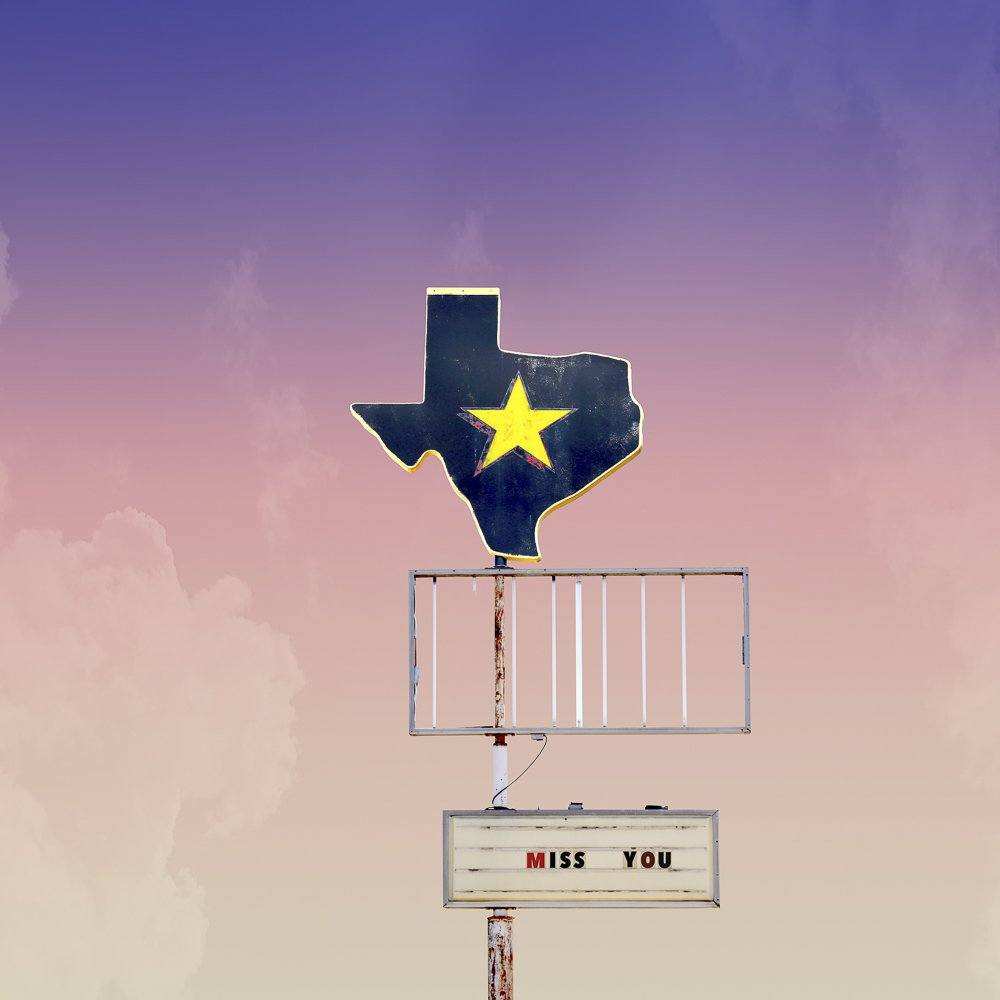 Texas Miss You Print by Crum Art featuring Texas shape with yellow star and "Miss You" sign on pastel sky background