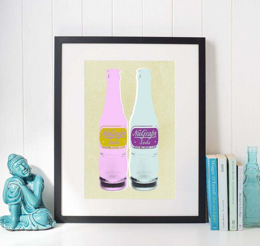Nugrape Soda Bottles art print by Betsy Crum in black frame on wall next to books and statue, colorful modern soda bottle illustration