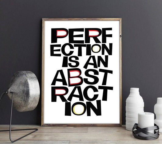 Framed museum print with the quote "Perfection is an Abstraction" in bold black letters with red and yellow highlights on white background.