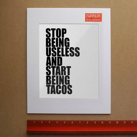Stop Being Useless and Start Being Tacos motivational print on white background with black text in white mat.