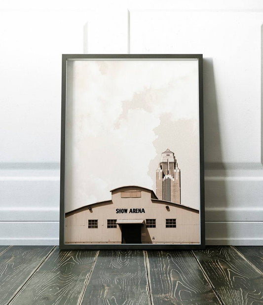 Framed sepia-toned Fort Worth Show Arena print with historic building and tower in background on wooden floor against white wall