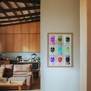 Nine Pearl Cans bar wall art print by Betsy Crum — framed in a wood-accent room