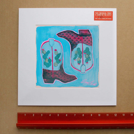 Cowboy boots and cactus colorful art print on white mat by Caya Crum