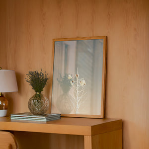 White Sands Yucca desert art print by Betsy Crum — framed in a wood-accent room