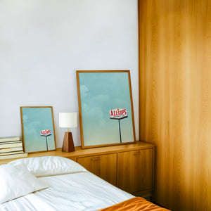 Allsup's Under a Big Sky Texas Art print by Betsy Crum — framed in a wood-accent room