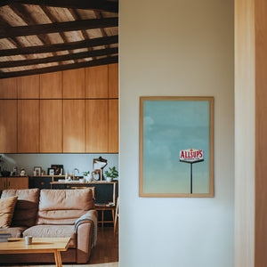 Allsup's Under a Big Sky Texas Art print by Betsy Crum — framed in a wood-accent room