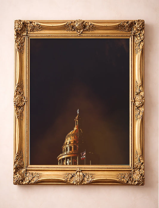 Texas State Capitol art print by Betsy Crum in a gold frame, the Austin capitol dome under a dark Texas sky