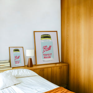 Ball Jar kitchen art print by Betsy Crum — framed in a wood-accent room