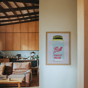 Ball Jar kitchen art print by Betsy Crum — framed in a wood-accent room