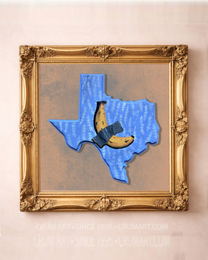 Banana Taped to Texas art print in a gold frame by Caya Crum — a banana duct-taped across a blue Texas-shaped plaque, funny wall art available at crumart.com. This museum quality print is made right here in Texas.