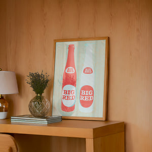 Big Red Two Bottles kitchen print by Betsy Crum — framed in a wood-accent room