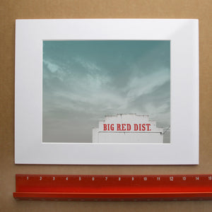 Big Red Building Big Sky Waco art print by Betsy Crum — with white mat