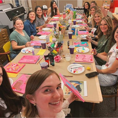 Boot Painting Workshop at the Crum Art studio in Fort Worth — the group around the table with their pink cowboy boot paintings