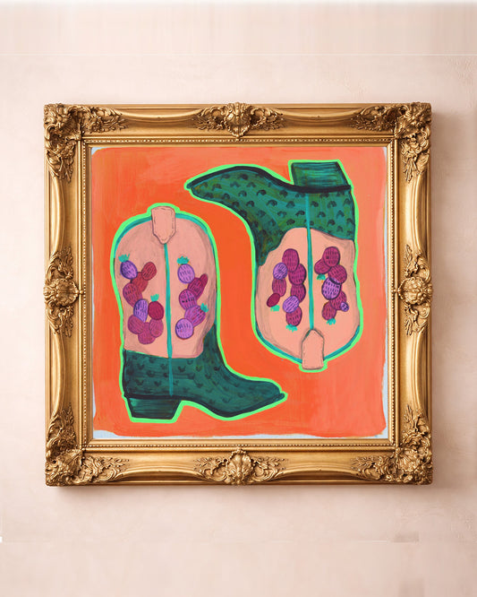 Prickly pear cowboy boots art print by Caya Crum in a square gold frame, orange western art