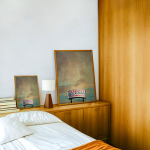 Carshons Deli Fort Worth art print by Betsy Crum — framed in a wood-accent room