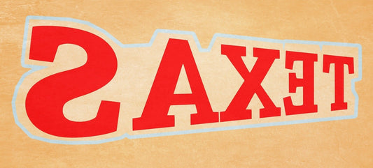 Cool Texas panoramic typography print by Betsy Crum, the word TEXAS in red letters running backwards on a warm tan background