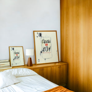 Coors Banquet bar wall art print by Betsy Crum — framed in a wood-accent room