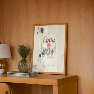 Coors Banquet bar wall art print by Betsy Crum — framed in a wood-accent room